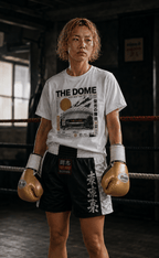 Boxer wearing The Dome white Japanese boxing T-shirt with gold gloves